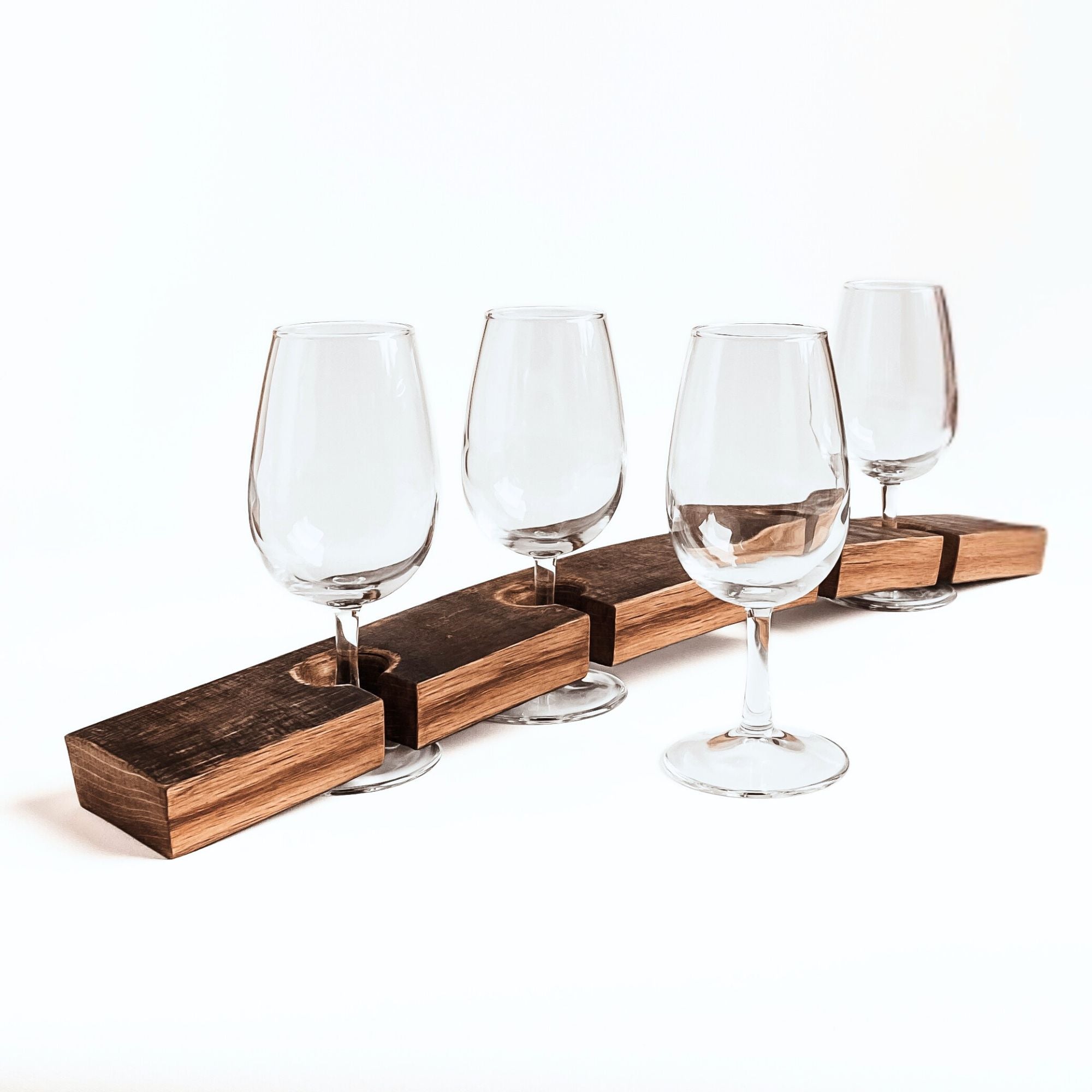 Barrel Stave wine flight tasting board with 4 wine glasses, one glass in front of the board