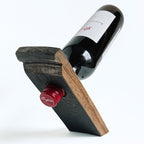 Barrel stave floating wine bottle holder with a red wine bottle on a white background, back view