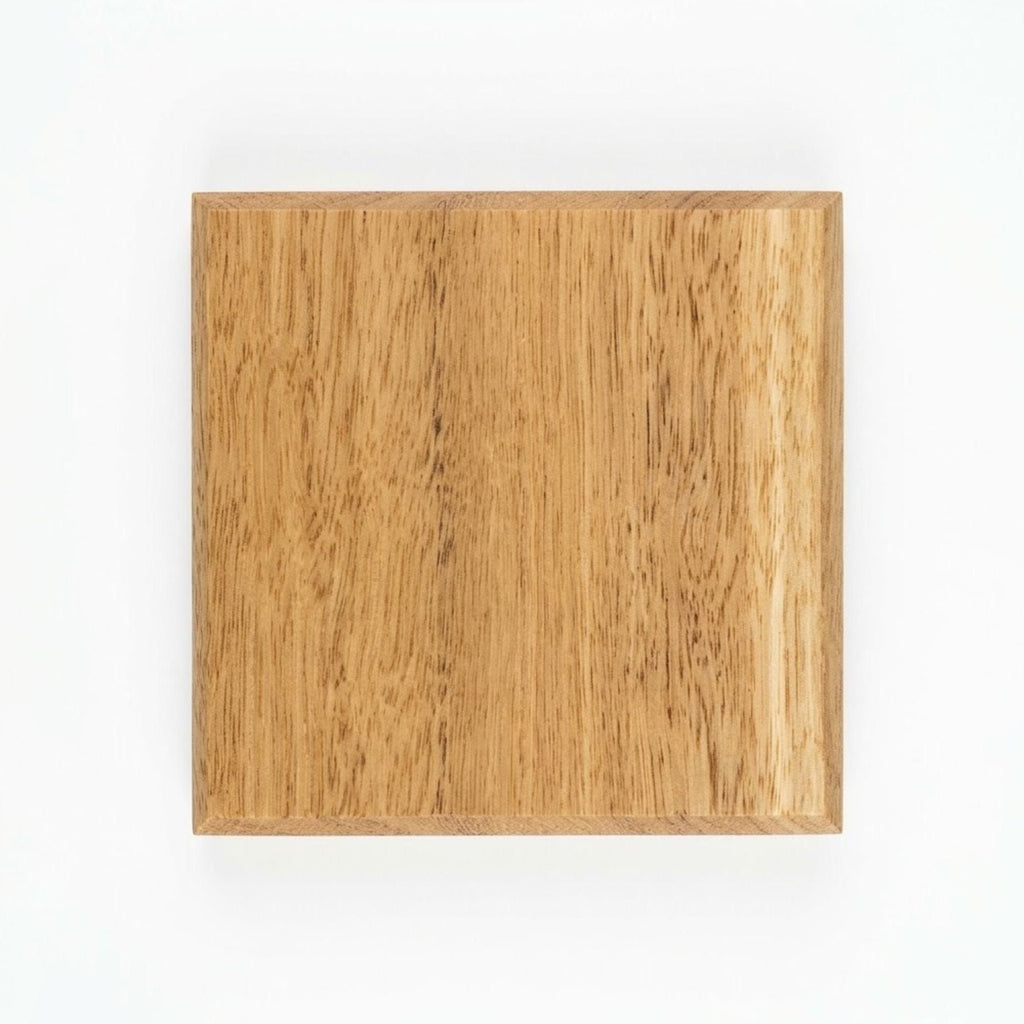 Handmade blackbutt hardwood coaster, top view showing chamfered edge and grain