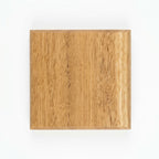 Handmade blackbutt hardwood coaster, top view showing chamfered edge and grain