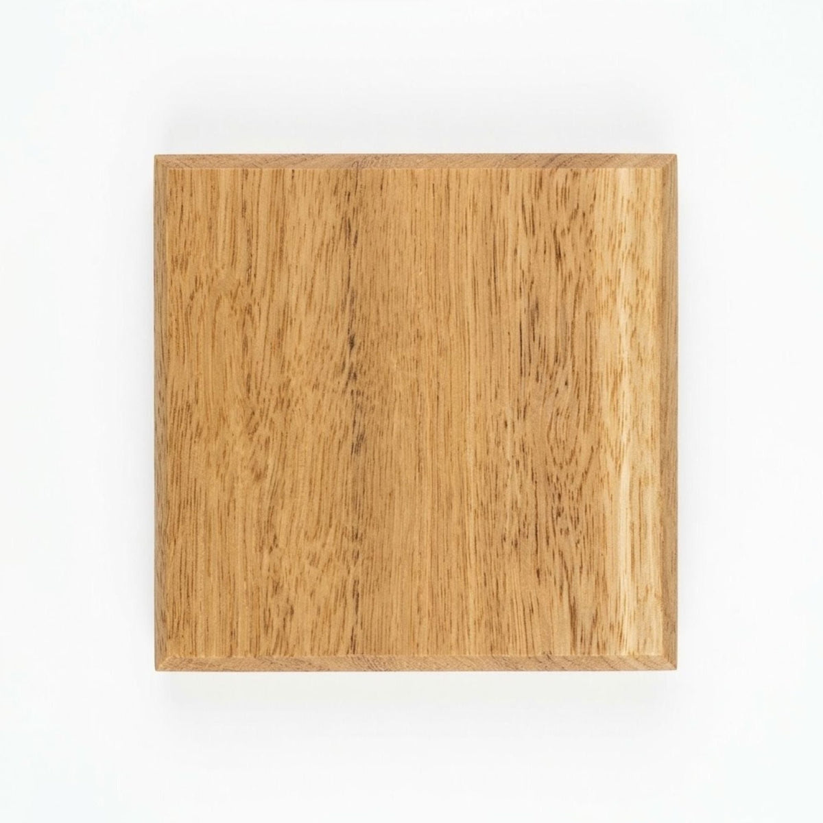 Handmade blackbutt hardwood coaster, top view showing chamfered edge and grain