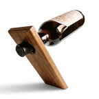 Wooden wine bottle holder with a wine bottle on a white background - underside view
