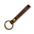 Personalised leather keyring engraved with 'Welcome Home', on a white background