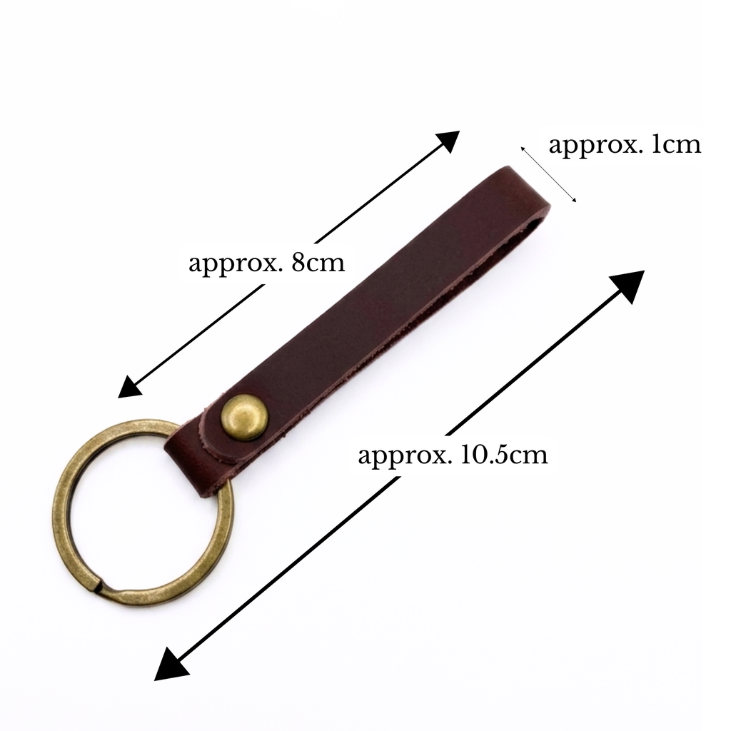 A brown leather keychain strap with a brass key ring and a brass rivet, shown with black dimension arrows and text labels indicating approximately 8 cm length, 10.5 cm total length, and 1 cm width.