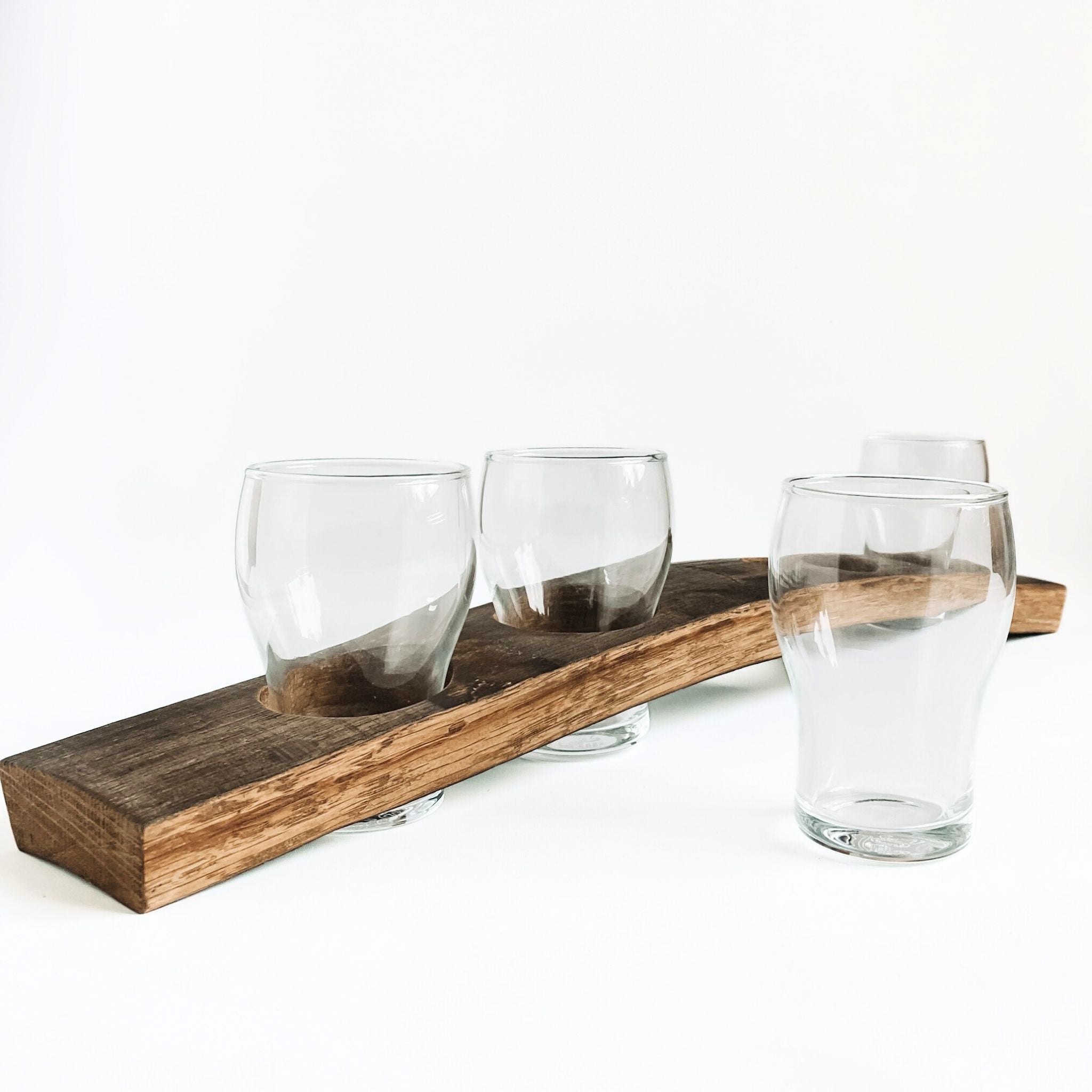 Barrel Stave beer flight tasting board with 4 beer tasting glasses, one glass in front of board