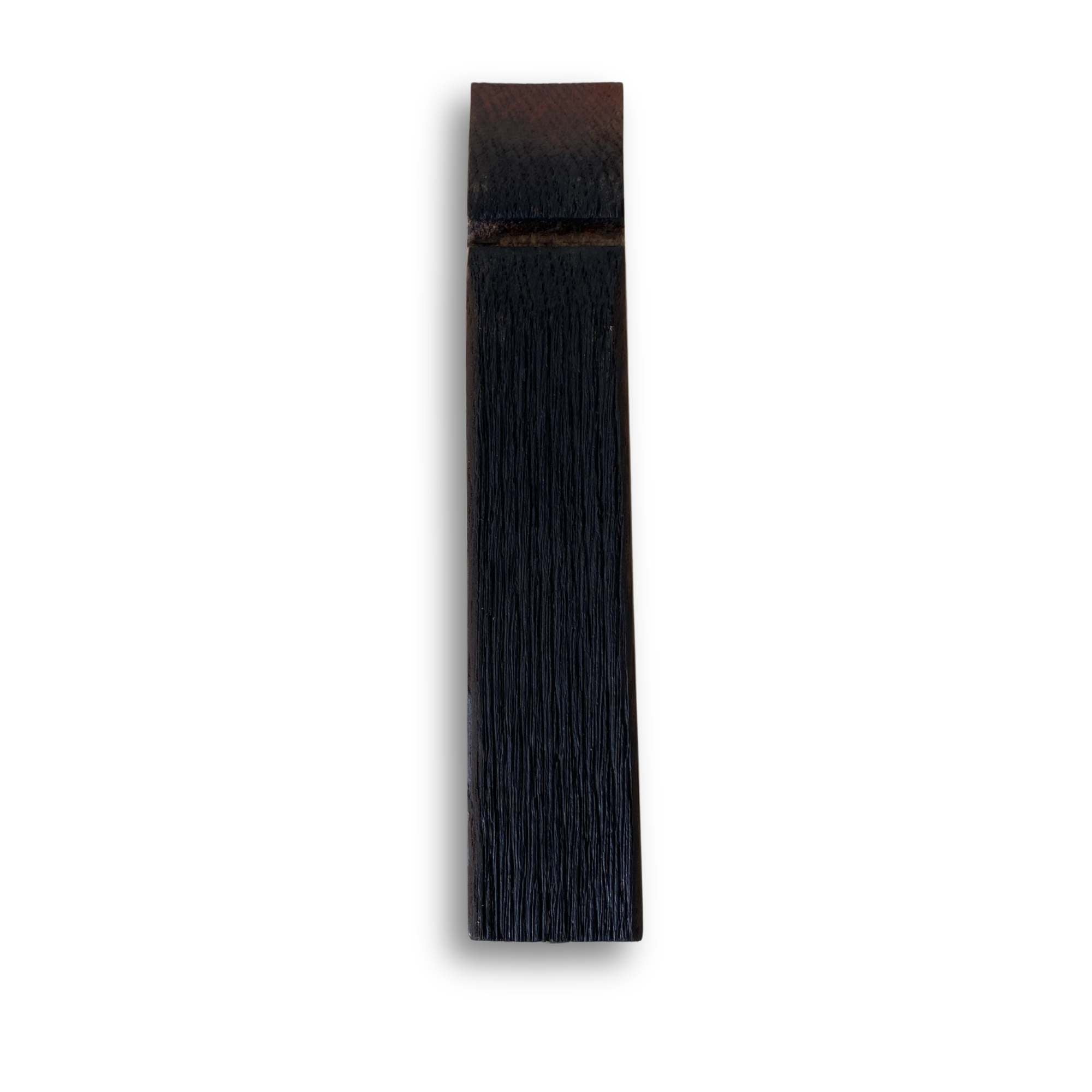Back of a barrel stave beer tap handle showing the charred inner face of the cask
