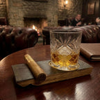 Barrel stave whisky coaster with a rocks glass of whisky and a cigar on a table