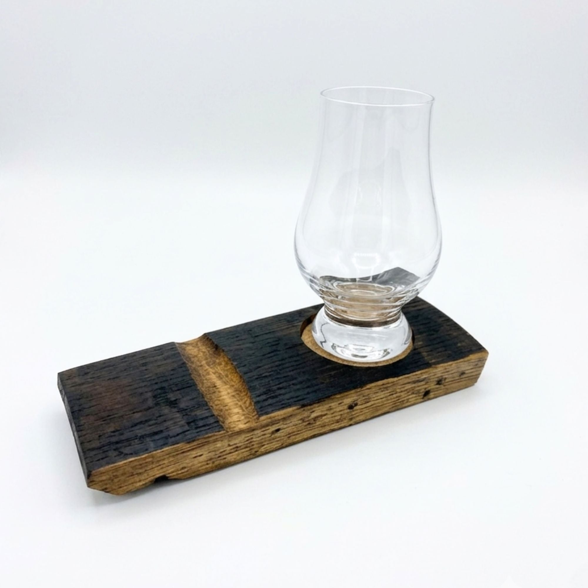 Barrel stave whisky coaster with a Glencairn glass resting in the cork-lined inset