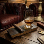 Barrel stave whisky coaster with a Glencairn glass of whisky and a cigar on a table