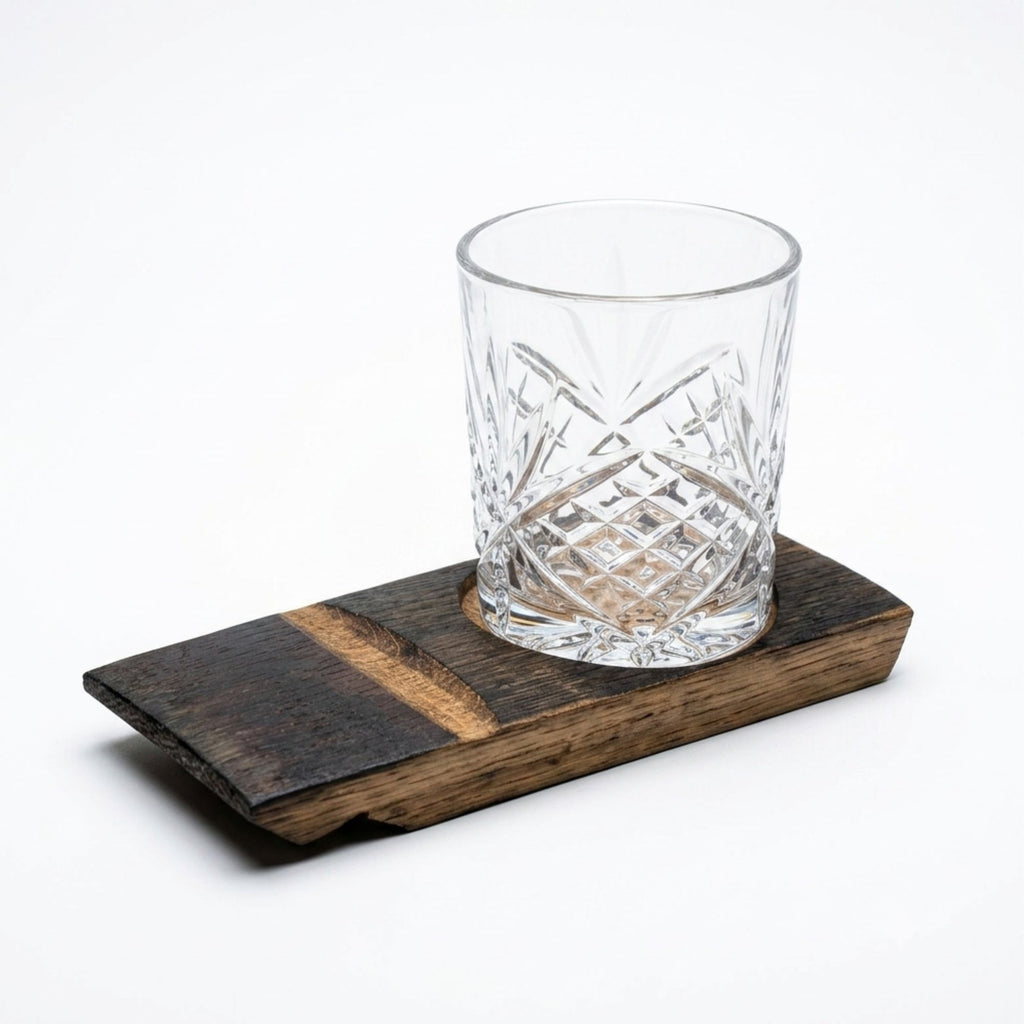 Barrel stave whisky coaster with a rocks glass resting in the cork-lined inset
