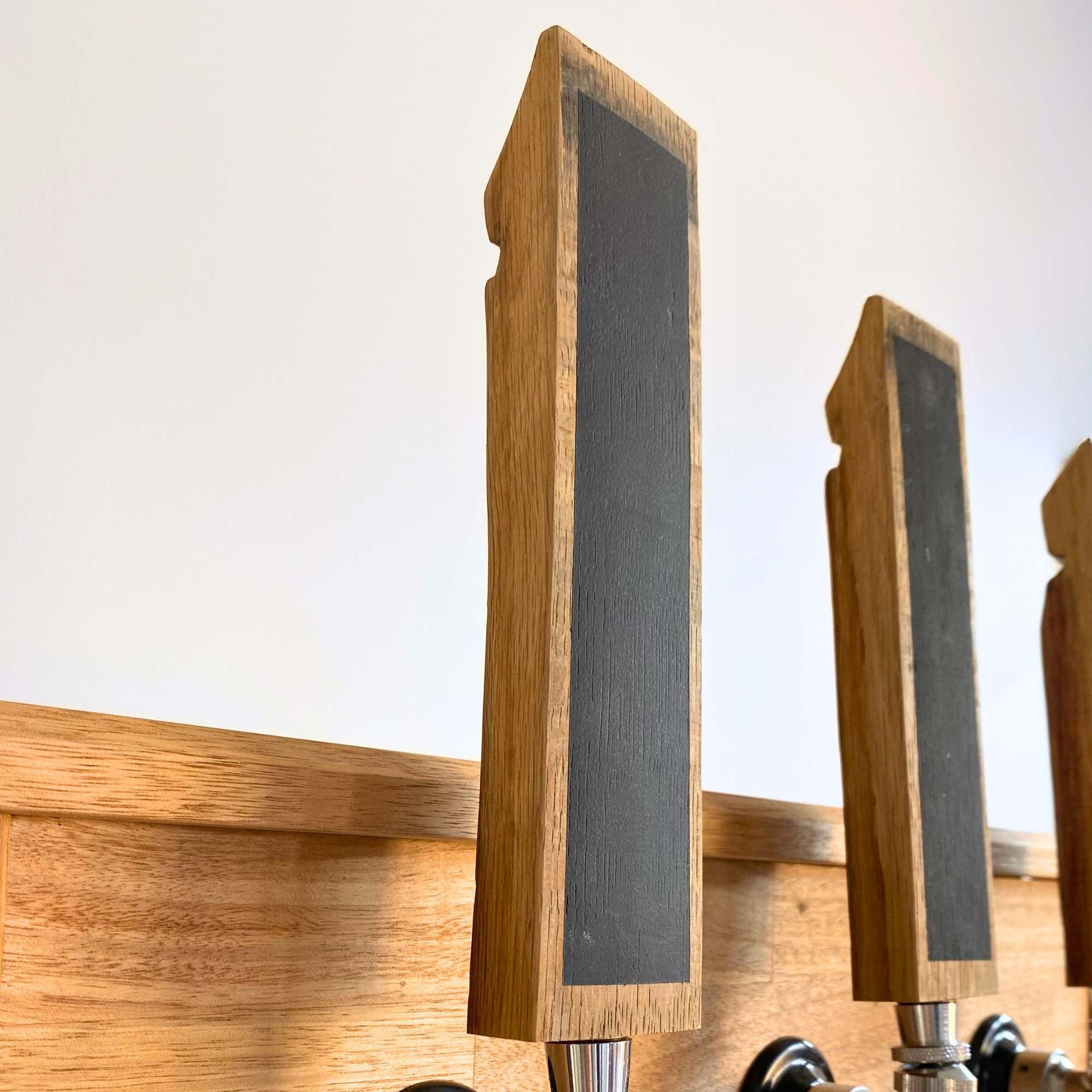 Barrel stave beer tap handle fitted to a home bar tap, side view
