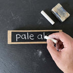 Writable chalkboard barrel stave beer tap handles being personalised with chalk
